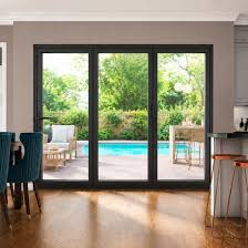 Three-panel vinyl sliding patio door with black frames overlooking a pool