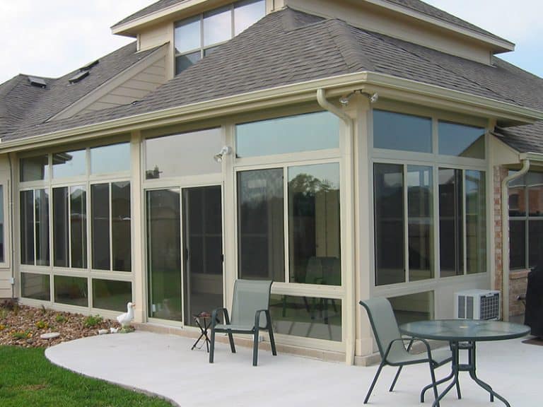 Three-season sunroom with insulated glass windows and patio furniture in Austin