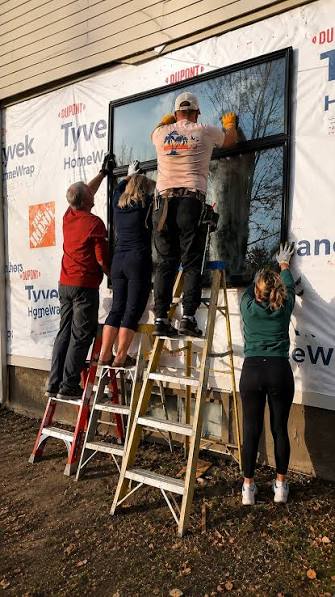 AWE Build crew installing a large window on a Texas home