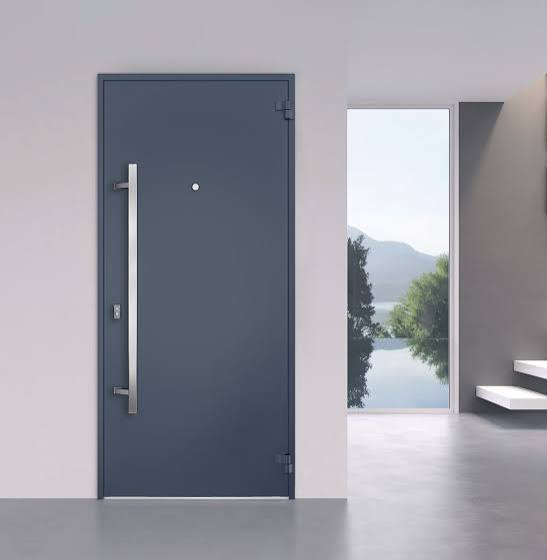 Modern dark steel entry door with a long vertical pull handle